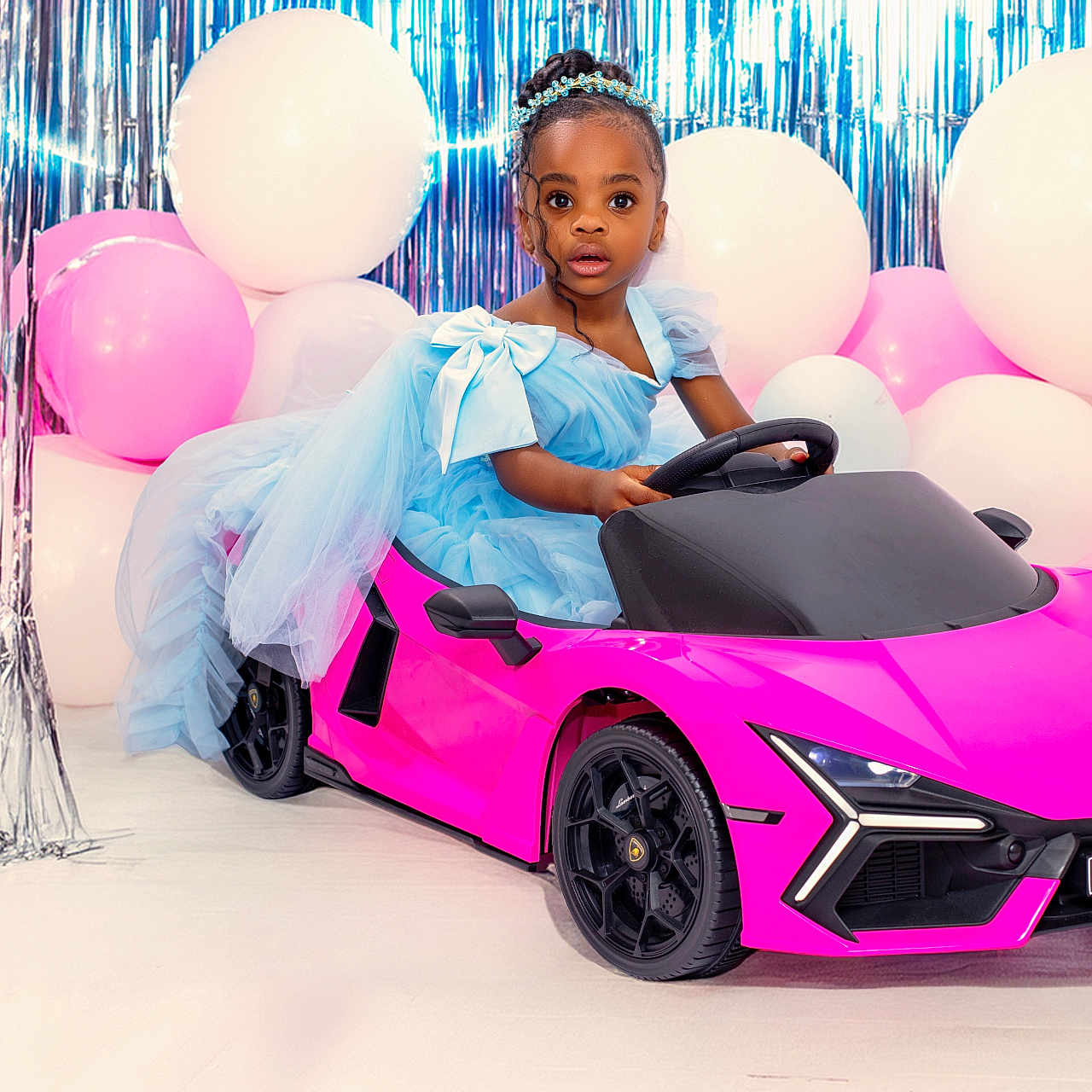 Khloe joined the competition — help win amazing prizes! child, girl, blue_dress, toy_car, pink_car, balloons, white_balloons, pink_balloons, party, celebration, streamers, indoor, portrait, cute, fashion, headband, floor, wheels, vehicle, fun