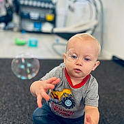 Hendrix joined the competition — help win amazing prizes! toddler, child, baby, bubble, indoor, carpet, reaching, curious, blue_eyes, casual_clothing, grey_shirt, jeans, socks, blond_hair, play, floor, focus, depth_of_field, home, cute
