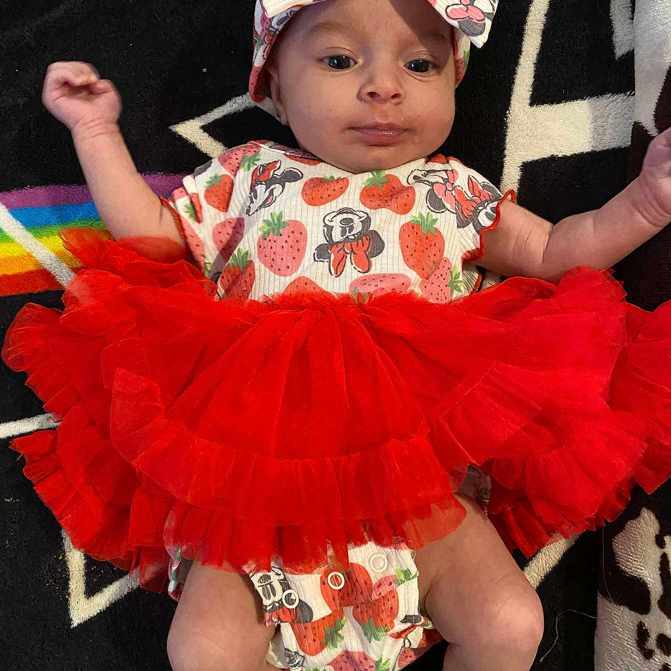 Iridessa joined the competition — help win amazing prizes! baby, baseballcap, bonnet, cap, clothing, costume, dress, face, footwear, hat, head, person, photography, portrait, sandal, shoe, shorts, sitting, skirt, sunhat