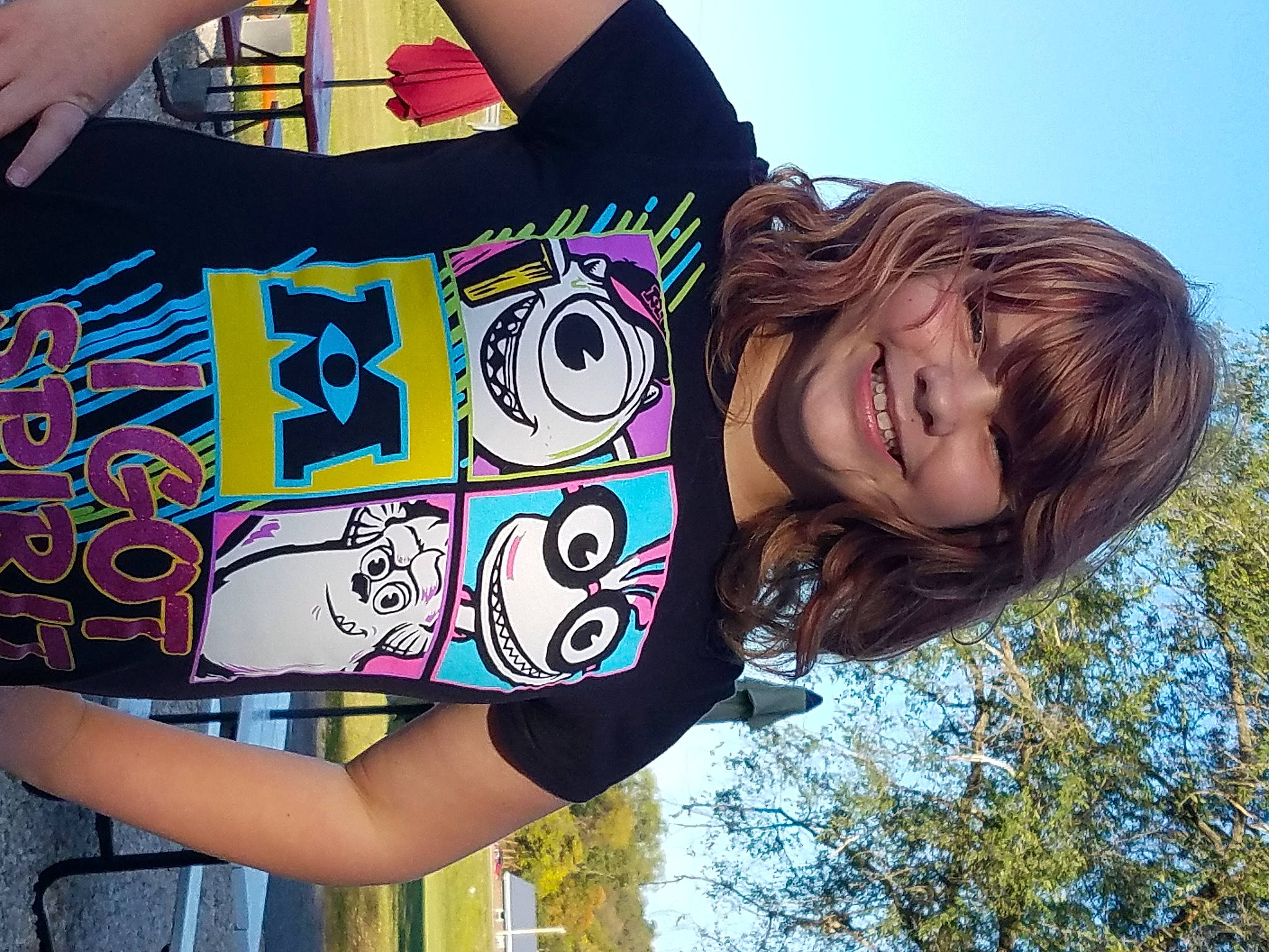 Kyla is registered to the contest to win money with this photo: arm, art, black, cool, gesture, green, happy, joint, joy, person, photograph, pink, plant, shoulder, sky, sleeve, smile, street_fashion, t_shirt, tree