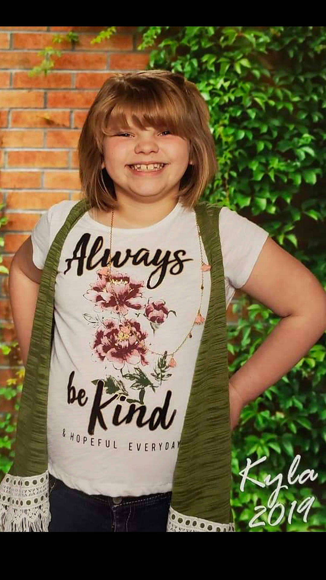 Kyla is registered to the contest to win money with this photo: cool, face, facial_expression, fashion, font, grass, happy, head, joy, leaf, mammal, neck, outerwear, people_in_nature, person, plant, sleeve, smile, street_fashion, summer