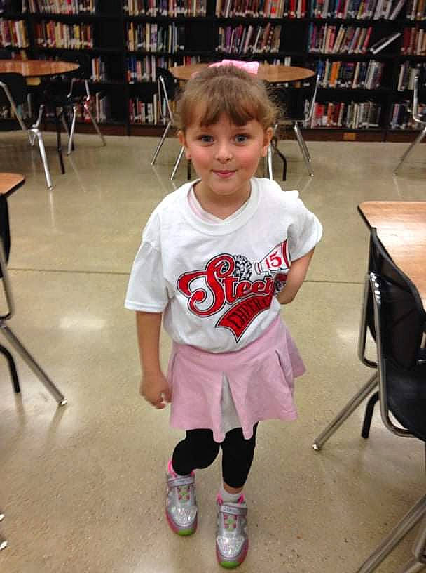 Kailey is registered to the contest to win money with this photo: baby_toddler_clothing, bookcase, chair, clothing, floor, flooring, footwear, furniture, happy, joint, joy, leg, person, photograph, shelf, shelving, shoe, sleeve, sneakers, sportswear