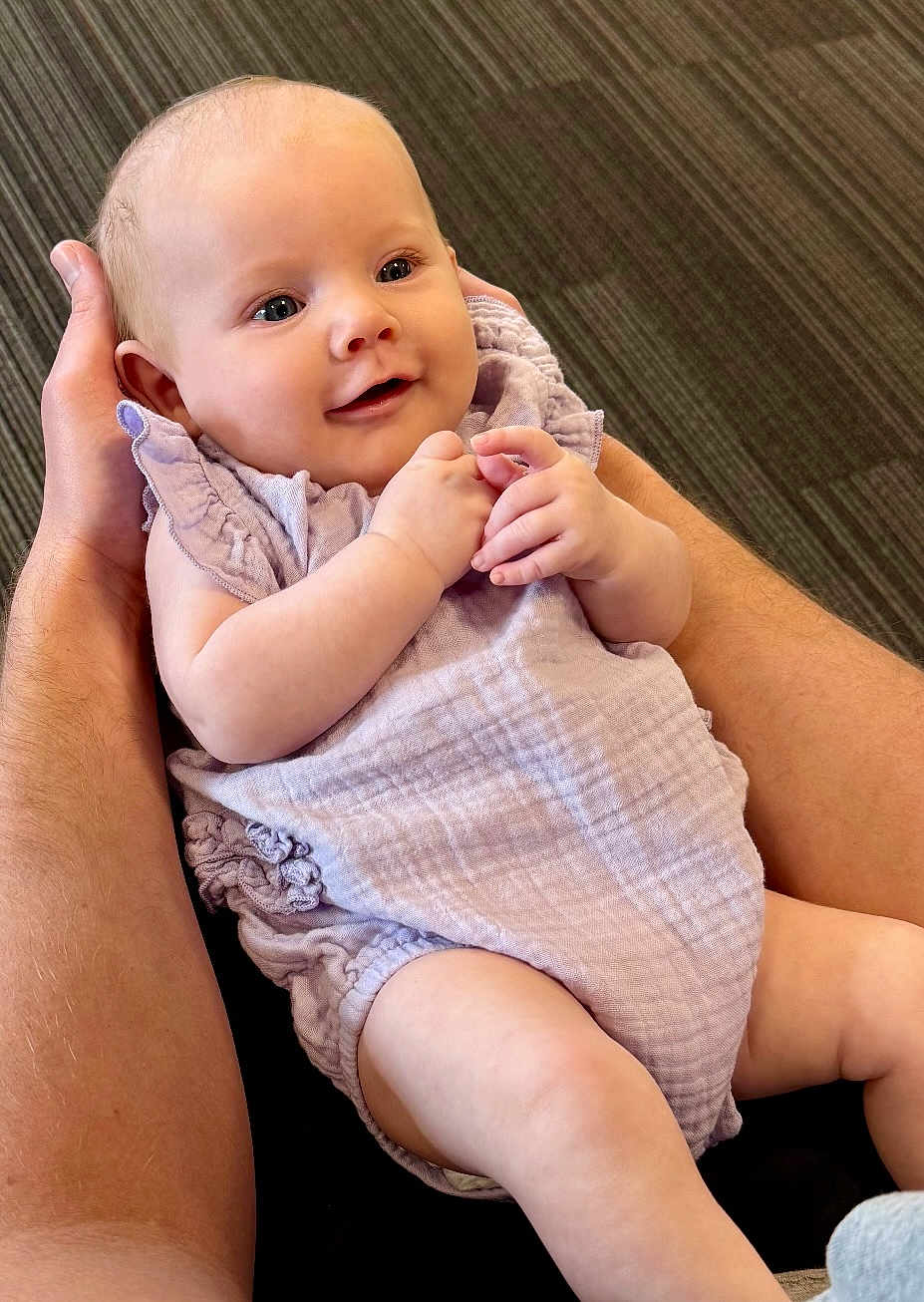 Ivy joined the competition — help win amazing prizes! baby, infant, smiling, hands, lavender_clothing, cute, portrait, skin, face, happy, child, person, flesh, sitting, young, newborn, arm, closeup, holding, background