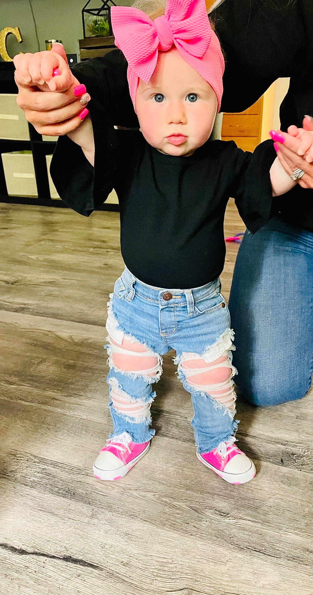 Tinsley is registered to the contest to win money with this photo: baby, baby_toddler_clothing, cool, denim, finger, gesture, hand, happy, headwear, joint, neck, person, pink, shoe, skin, sleeve, sneakers, standing, t_shirt, thigh