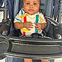 baby, child, stroller, colorful_clothing, striped_shirt, shoes, infant, seatbelt, portrait, cute, indoor, person, hands, face, eyes, expression, casual, young_child, seat, footwear