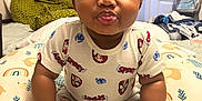 Jhamir joined the competition — help win amazing prizes! baby, child, cute, smiling, tongue_out, sitting, spiderman, clothing, pillow, pattern, indoor, blanket, bed, socks, person, face, curly_hair, happy, home, playful