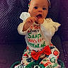 baby, bow, celebration, child, christmas, clothing, couch, cute, festive, happy, headband, holiday, indoors, infant, pajamas, portrait, sitting, smiling, sparkle, text_overlay