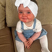 Gabriella joined the competition — help win amazing prizes! baby, bow, child, couch, cute, denim_dress, furniture, girl, hands, happy, headband, indoors, infant, person, portrait, rosy_cheeks, sitting, skin, smile, white_tights