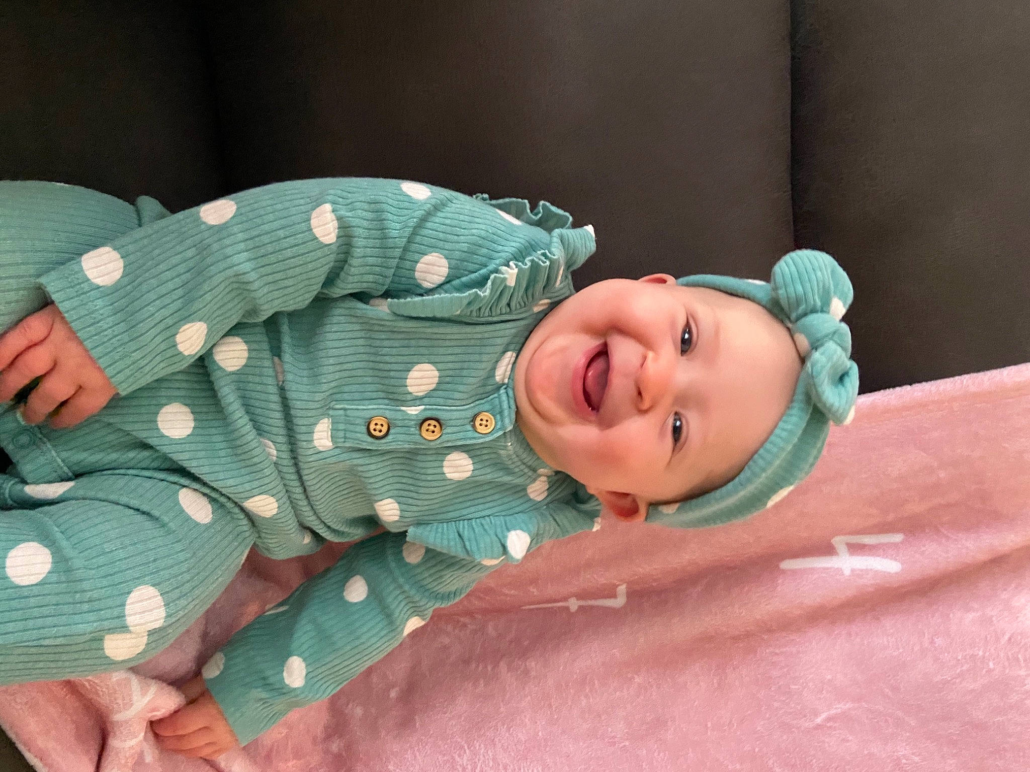 Savanna is registered to the contest to win money with this photo: arm, baby, baby_products, baby_sleeping, baby_toddler_clothing, child, collar, comfort, fashion_accessory, happy, headwear, joy, laugh, linens, pattern, person, portrait_photography, sitting, skin, sleeve