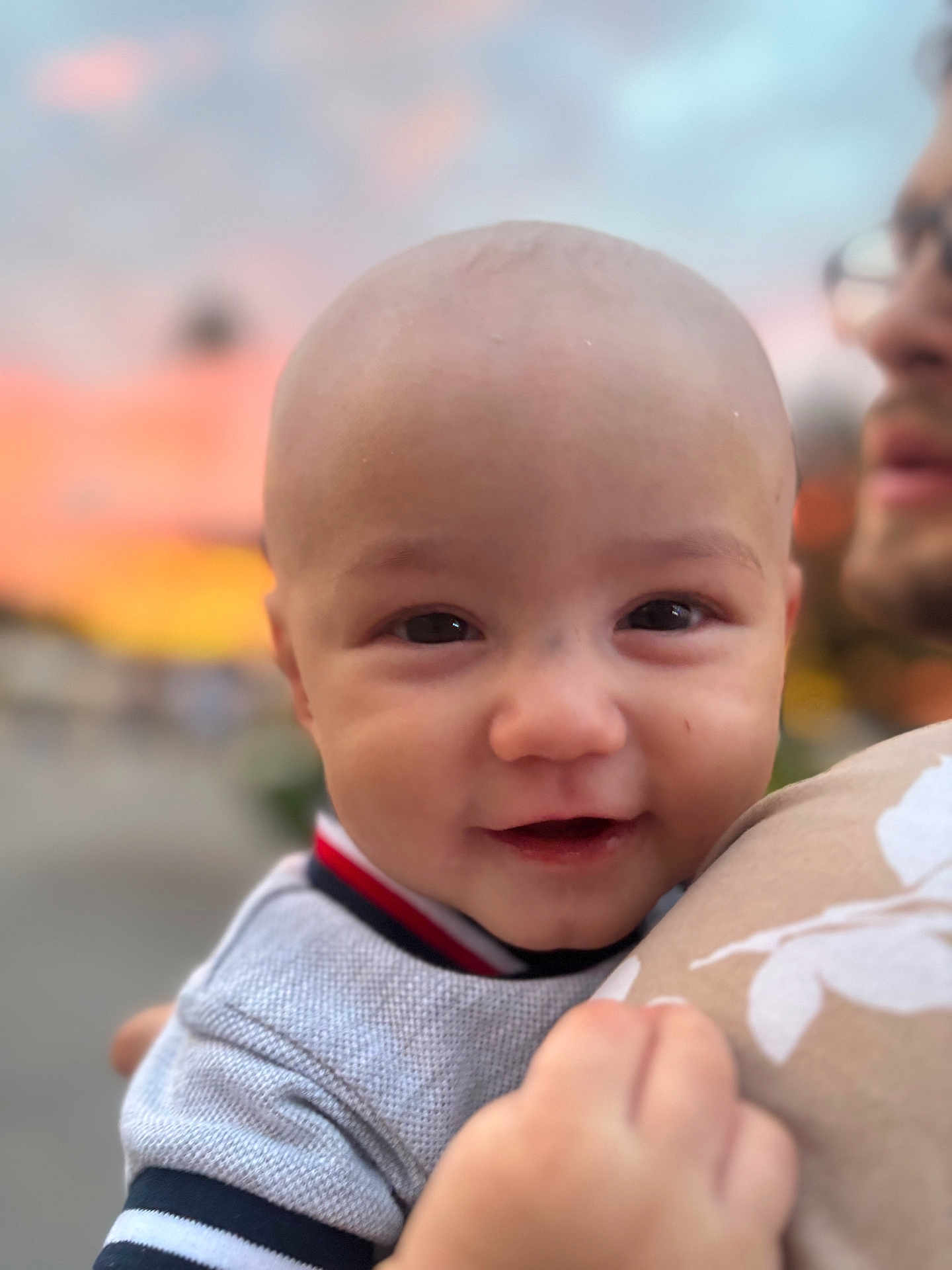Ezekiel joined the competition — help win amazing prizes! baby, child, smiling, face, person, adult, holding, closeup, outdoor, sunset, sky, happy, portrait, head, clothing, hand, toddler, cute, warm, blurred_background
