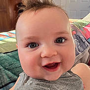 Levi is registered to the contest to win money with this photo: baby, smiling, face, child, hair, indoor, closeup, eyes, expression, joy, happy, skin, person, clothing, background, blanket, door, head, portrait, infant