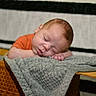 Rodrick joined the competition — help win amazing prizes! baby, blanket, closed_eyes, cozy, cushion, face, gray_blanket, hands, head, indoor, infant, nap, newborn, orange_shirt, peaceful, photograph, portrait, resting, sleeping, woven_basket