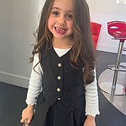 Nina a rejoint le concours — aidez-le/la à gagner de superbes lots ! child, girl, smile, long_hair, black_dress, white_shirt, standing, indoor, red_chair, modern_interior, floor, happy, fashion, portrait, person, cute, boots, young, hair, casual