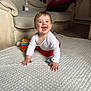 Eleanor is registered to the contest to win money with this photo: baby, bottle, carpet, child, crawling, cute, face, floor, furniture, hands, happy, home, indoor, living_room, red_pants, smiling, sofa, toy_block, white_blanket, white_shirt