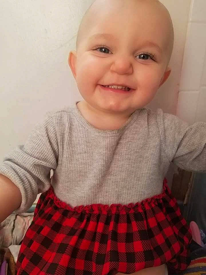 Arraya is registered to the contest to win money with this photo: baby, baby_toddler_clothing, cheek, child, chin, design, eye, face, facial_expression, head, joy, lip, nose, pattern, person, plaid, skin, smile, standing, tartan
