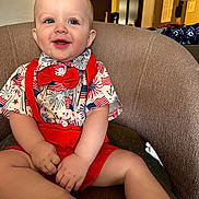 Braxton joined the competition — help win amazing prizes! baby, child, smiling, red_bow_tie, red_suspender, shorts, shirt, indoor, chair, seated, happy, cute, portrait, blue_eyes, light_skin, hands, feet, furniture, casual_clothing, home