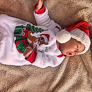 Braylin joined the competition — help win amazing prizes! baby, christmas, holiday_clothing, santa_hat, reindeer_slippers, blanket, infant, cute, festive, warm, sleepwear, soft, portrait, lying_down, holiday, child, smiling, indoors, happy, cozy