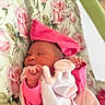 newborn, baby, sleeping, pink_clothing, hat, blanket, floral_pattern, cozy, soft, cute, infant, peaceful, resting, child, portrait, indoors, closeup, wrapped, toddler, headwear