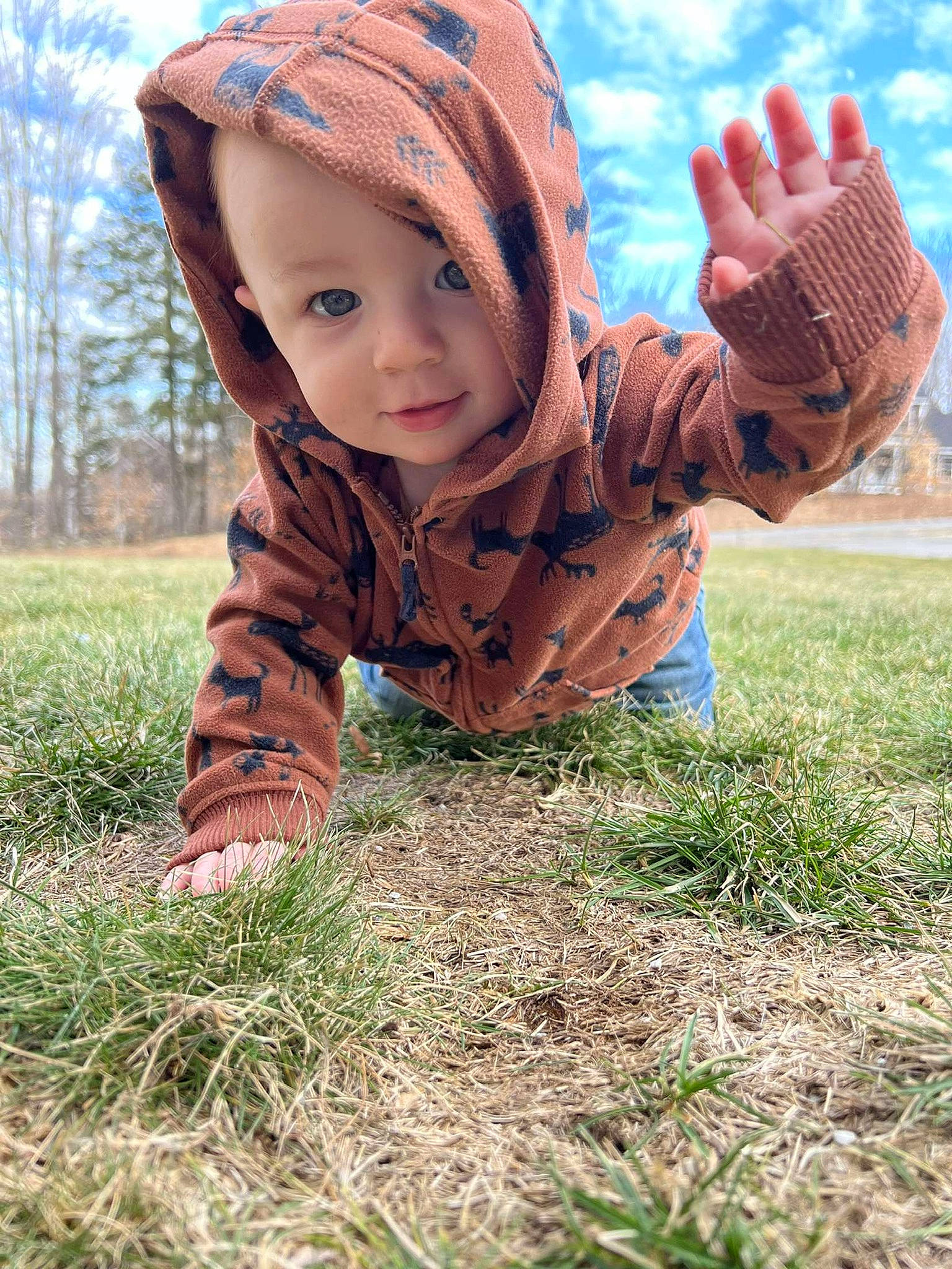 Atticus is registered to the contest to win money with this photo: cap, child, field, fun, gesture, grass, grassland, hand, happy, headwear, landscape, leisure, meadow, people_in_nature, person, plant, sitting, sky, soil, toddler