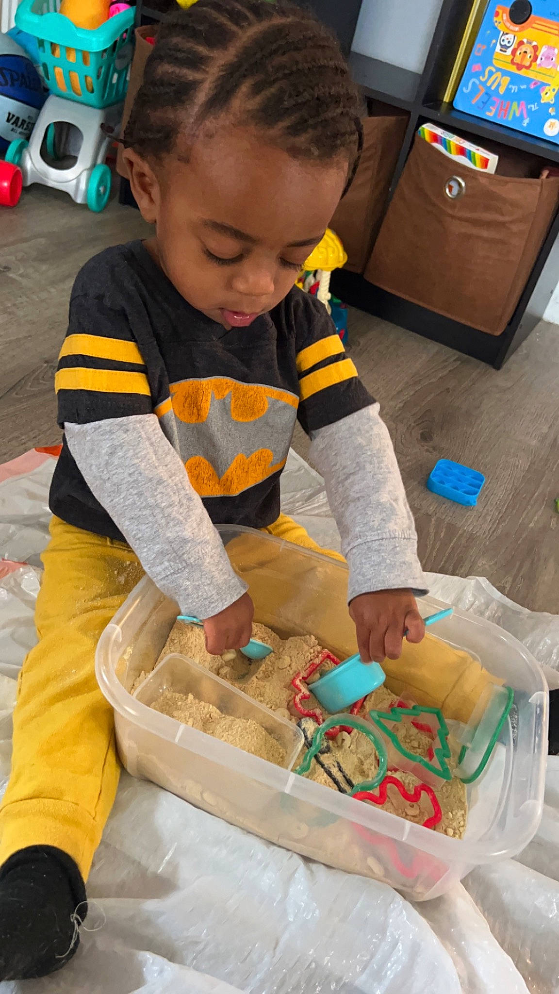 Jeffrey is registered to the contest to win money with this photo: baby, bag, box, cardboard, child, event, flooring, fun, linens, luggage_and_bags, person, plastic_bag, play, room, shipping_box, sitting, soil, t_shirt, toddler, wheel