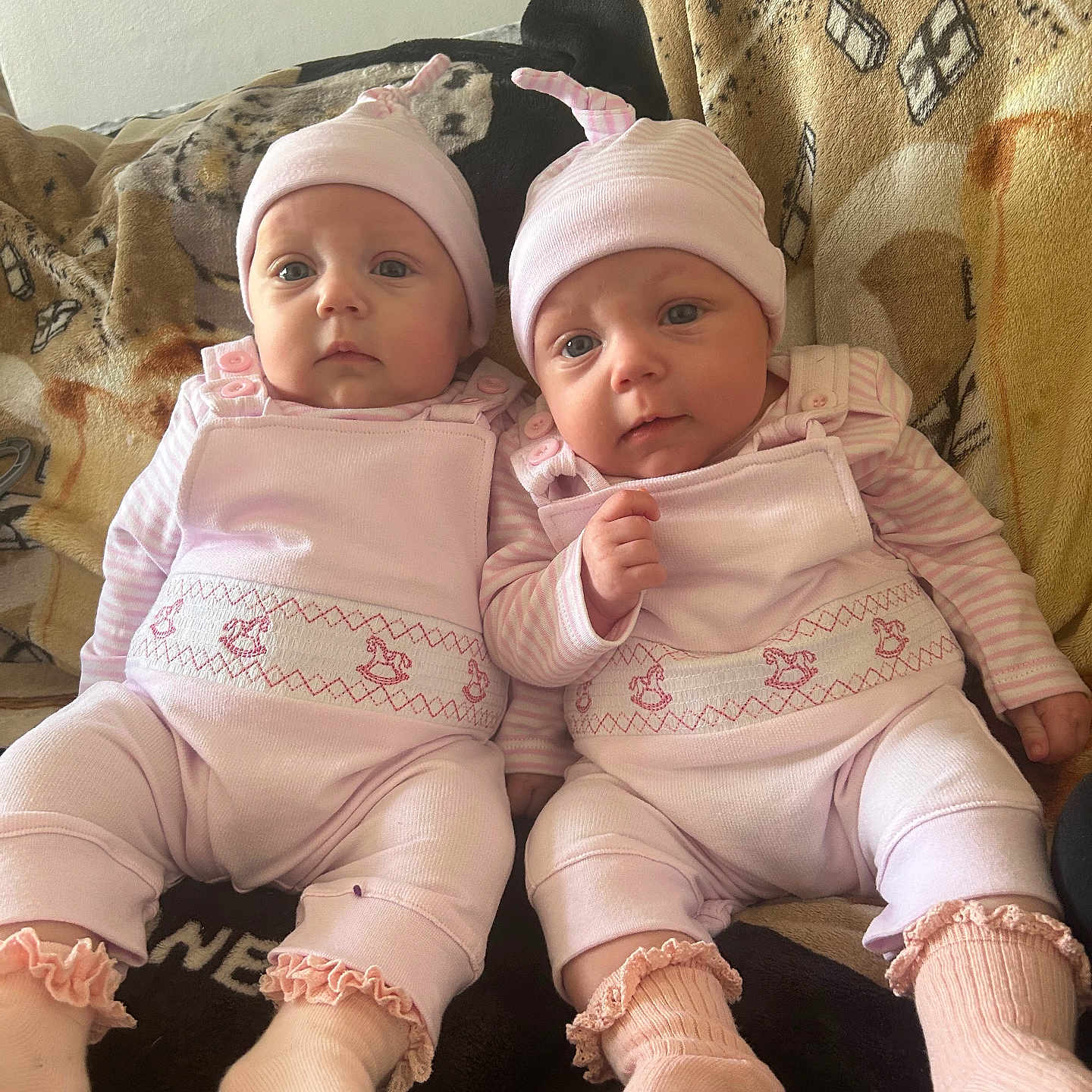 Lylee And Biddi joined the competition — help win amazing prizes! baby, baby_clothes, blanket, child, couch, cute, hat, indoor, infant, newborn, people, pink_clothing, portrait, resting, seated, smiling, socks, soft_lighting, twins, two_people