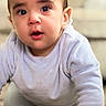 Matteo is registered to the contest to win money with this photo: baby, child, crawling, carpet, indoor, curious, face, hands, blue_clothing, long_sleeve, person, young_child, closeup, portrait, home, furniture, soft_light, expression, floor, cute