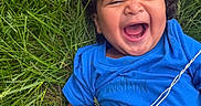 Noah joined the competition — help win amazing prizes! toddler, child, laughing, grass, greenery, blue_shirt, outdoor, happy, smile, curly_hair, hand, nature, baby, joy, playful, person, young_child, casual_clothing, closeup, summer