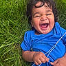 toddler, child, laughing, grass, greenery, blue_shirt, outdoor, happy, smile, curly_hair, hand, nature, baby, joy, playful, person, young_child, casual_clothing, closeup, summer