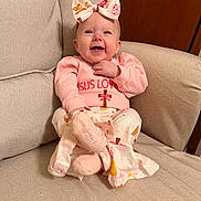 Kazelynn is registered to the contest to win money with this photo: armchair, baby, bow, child, clothing, cozy, cute, face, happy, headband, indoors, infant, patterned_fabric, person, pink_clothing, portrait, sitting, smiling, soft_lighting, young_child