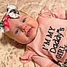 Kazelynn joined the competition — help win amazing prizes! adorable, baby, blanket, blue_eyes, bow, cheeks, child, close_up, cute, face, headband, indoor, infant, lying_down, pink_clothing, portrait, smiling, soft_texture, text_on_clothing, tongue_out