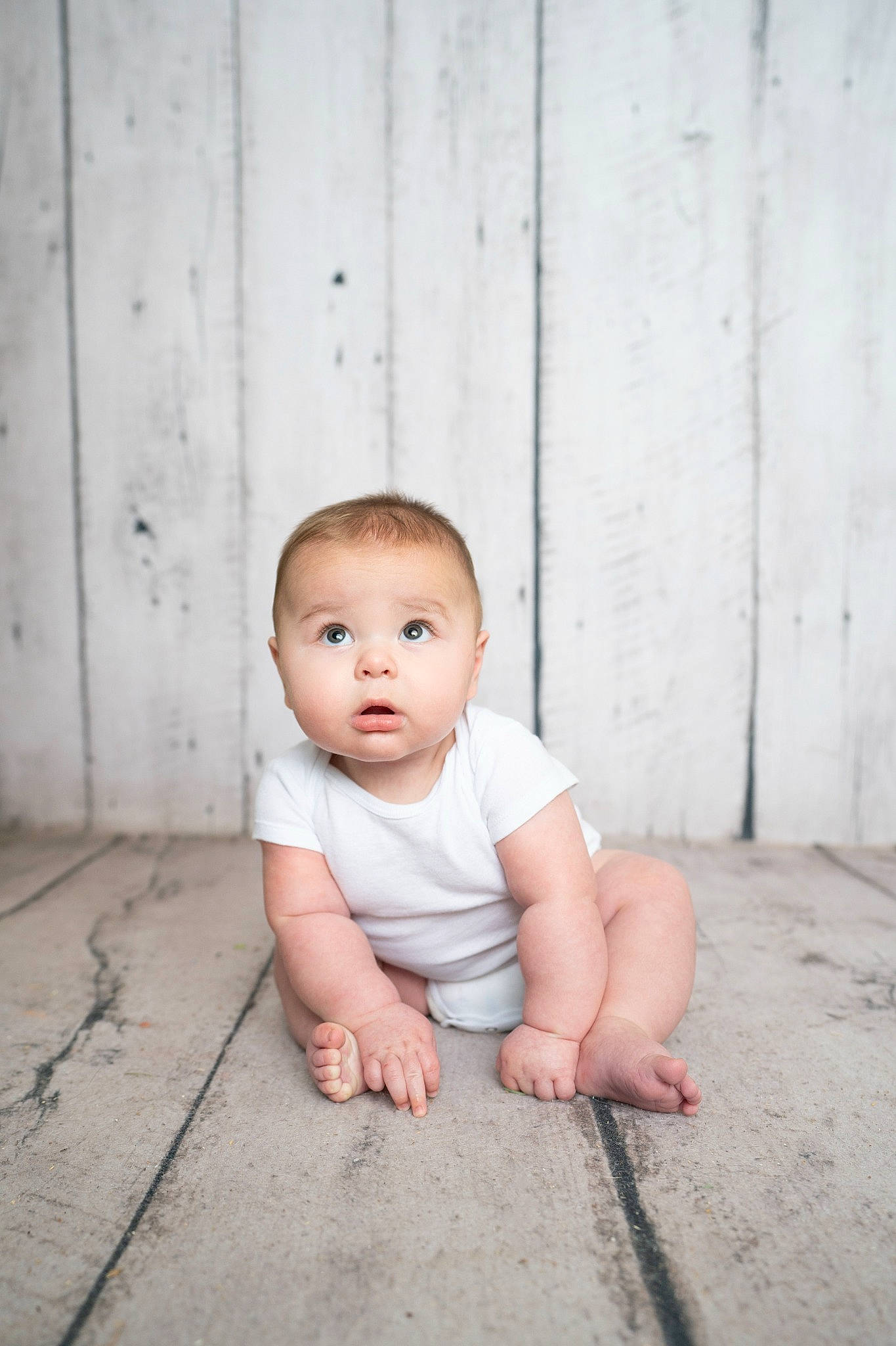 Cooper is registered to the contest to win money with this photo: baby, baby_toddler_clothing, cheek, child, flash_photography, floor, flooring, foot, grass, grey, happy, hardwood, monochrome, monochrome_photography, person, portrait_photography, sitting, skin, surprise, toddler
