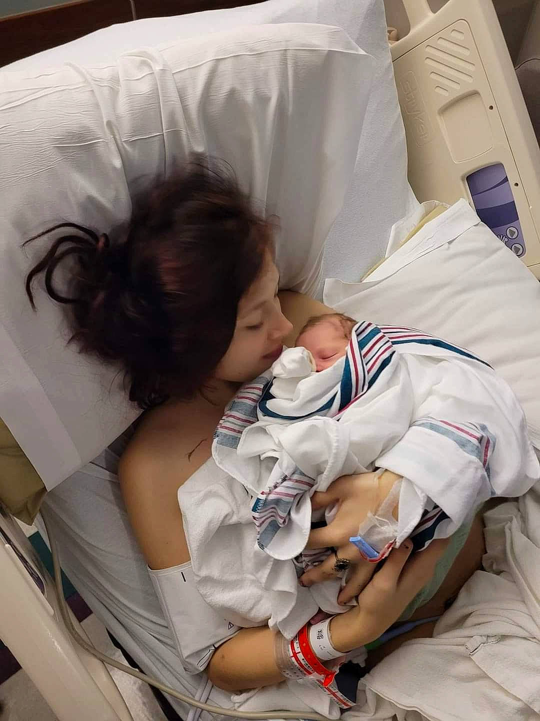 Alaina is registered to the contest to win money with this photo: baby, baby_products, baby_sleeping, child, childbirth, comfort, elbow, event, health_care, hospital, hospital_bed, linens, medical, medical_equipment, medical_procedure, nap, patient, person, room, service