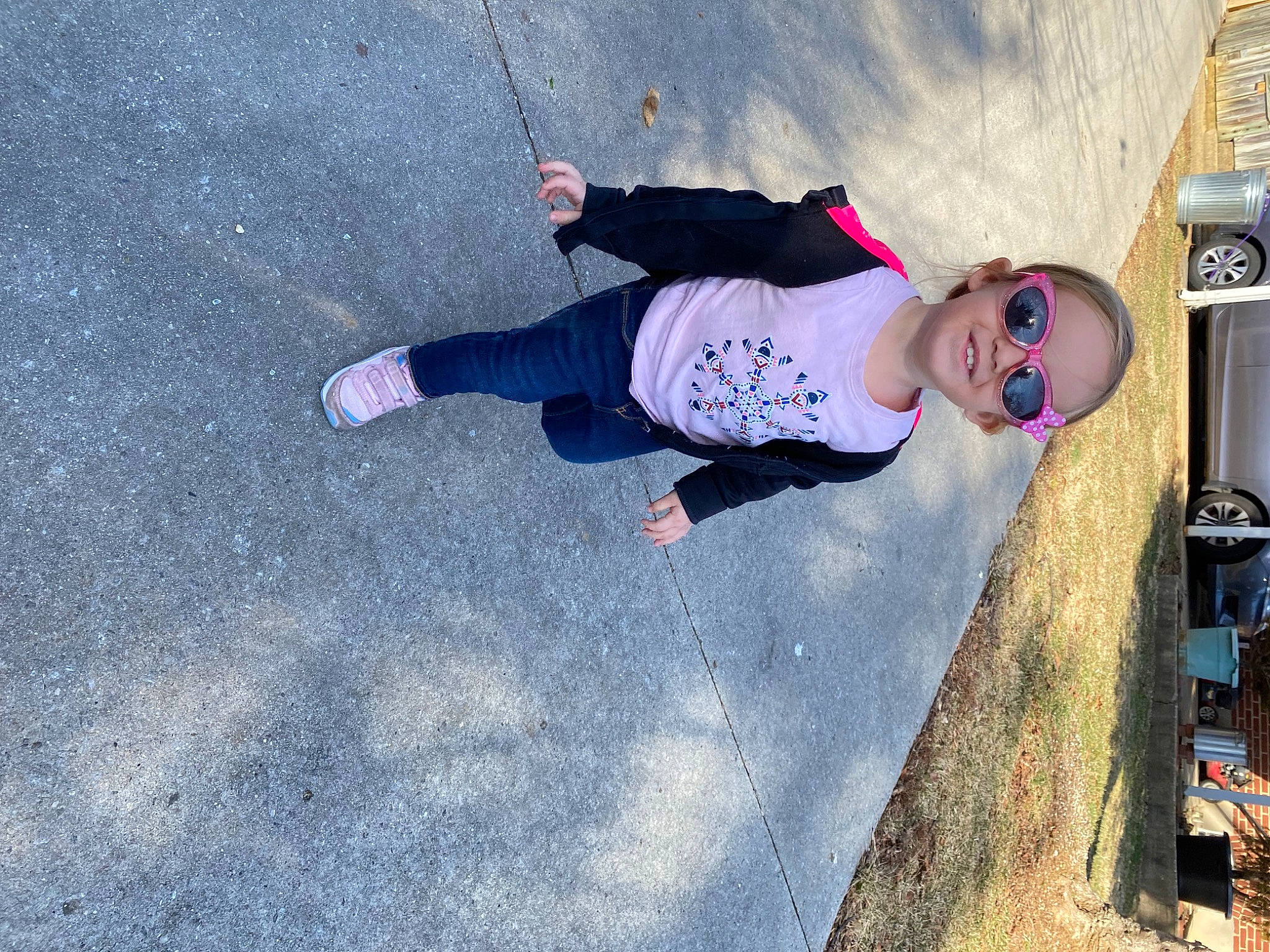 Isabella is registered to the contest to win money with this photo: adventure, asphalt, automotive_tire, car, concrete, cool, electric_blue, fun, joy, leisure, person, recreation, road_surface, shadow, soil, t_shirt, tire, toddler, tree, vehicle_door