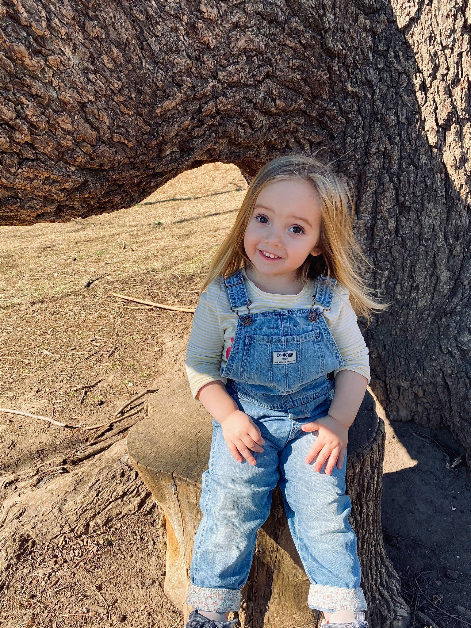 Isabella is registered to the contest to win money with this photo: clothing, denim, dress, eye, facial_expression, flash_photography, grass, hair, happy, head, jeans, joy, leg, people_in_nature, person, shoe, skin, smile, tree, trunk