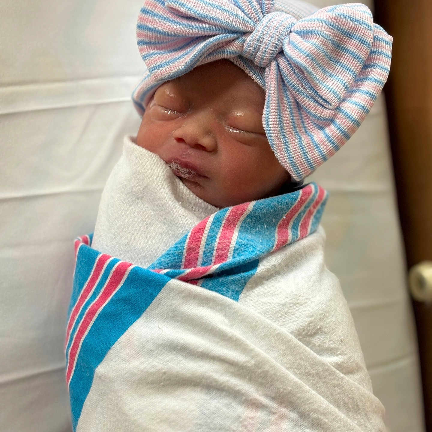 Abryanah is registered to the contest to win money with this photo: baby, blanket, bow, child, closeup, cute, face, hat, headwear, hospital, human, infant, newborn, peaceful, portrait, resting, sleeping, soft, swaddled, wrapped