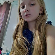 Kyeisha is registered to the contest to win money with this photo: child, girl, long_hair, blonde_hair, indoor, curtain, door, casual, portrait, selfie, expression, blue_clothing, home, room, face, person, young, hair, light, window