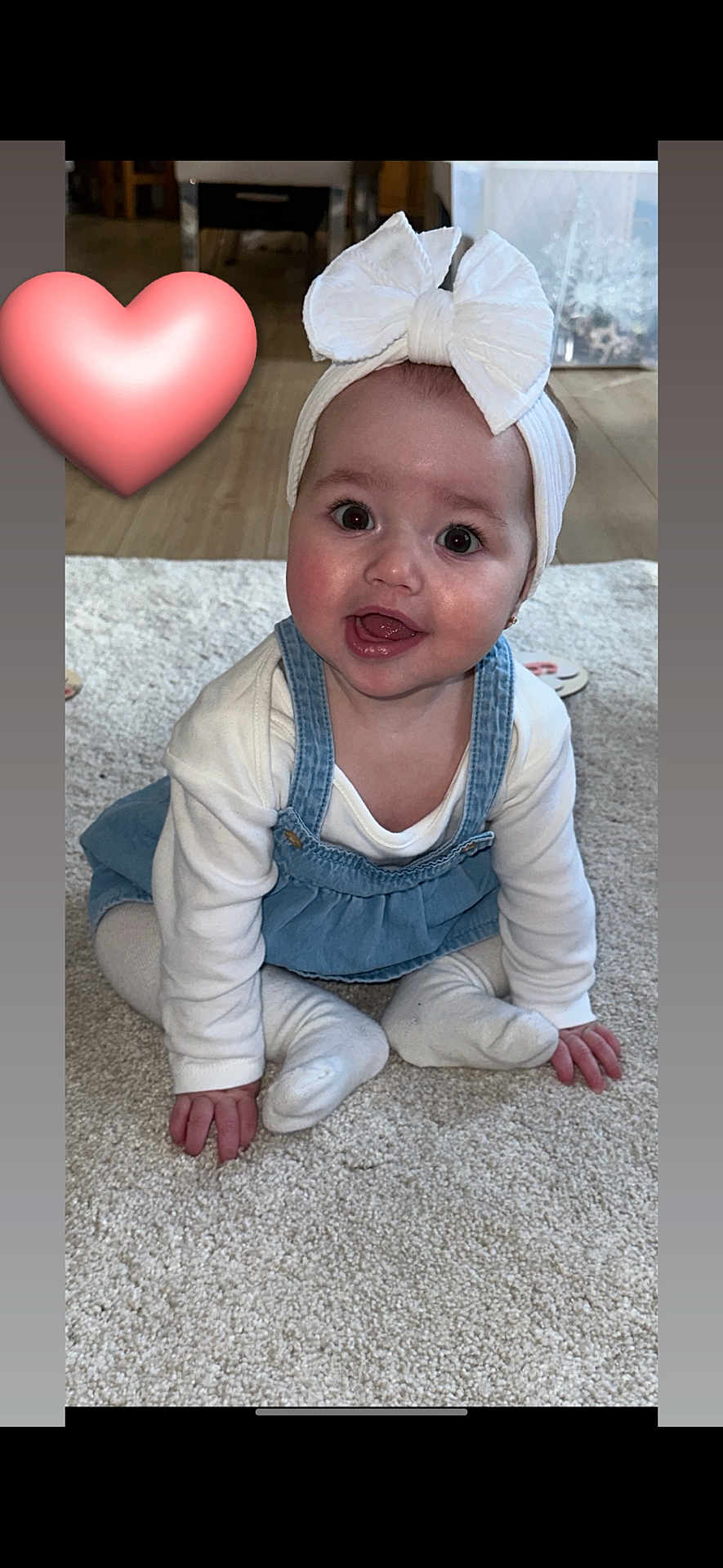Darcy joined the competition — help win amazing prizes! baby, child, headband, bow, smile, carpet, indoor, denim, dress, white_clothing, cute, happy, sitting, toddler, person, floor, heart_emoji, hand, face, eyes