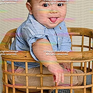 Mateo joined the competition — help win amazing prizes! baby, beige_pants, blue_shirt, candid, child, cute, expression, floor, funny_face, indoor, infant, person, playful, portrait, sitting, smiling, tongue_out, wood, wooden_basket, young_child