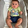 baby, baby_seat, barefoot, buzz_lightyear, child, comfortable, cute, face, flooring, happy, indoors, infant, patterned_fabric, person, shorts, sitting, smiling, tshirt, wood_floor, young_child