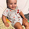 baby, blanket, child, clothing, cozy, cushion, eyes, face, hair, happy, indoor, infant, lobster_pattern, photography, playful, portrait, romper, sitting, smiling, toy