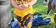 Charlotte is registered to the contest to win money with this photo: animal, barefoot, child, clothing, face, female, girl, grass, hat, head, nature, outdoors, park, person, photography, plant, portrait, shorts, summer, t_shirt
