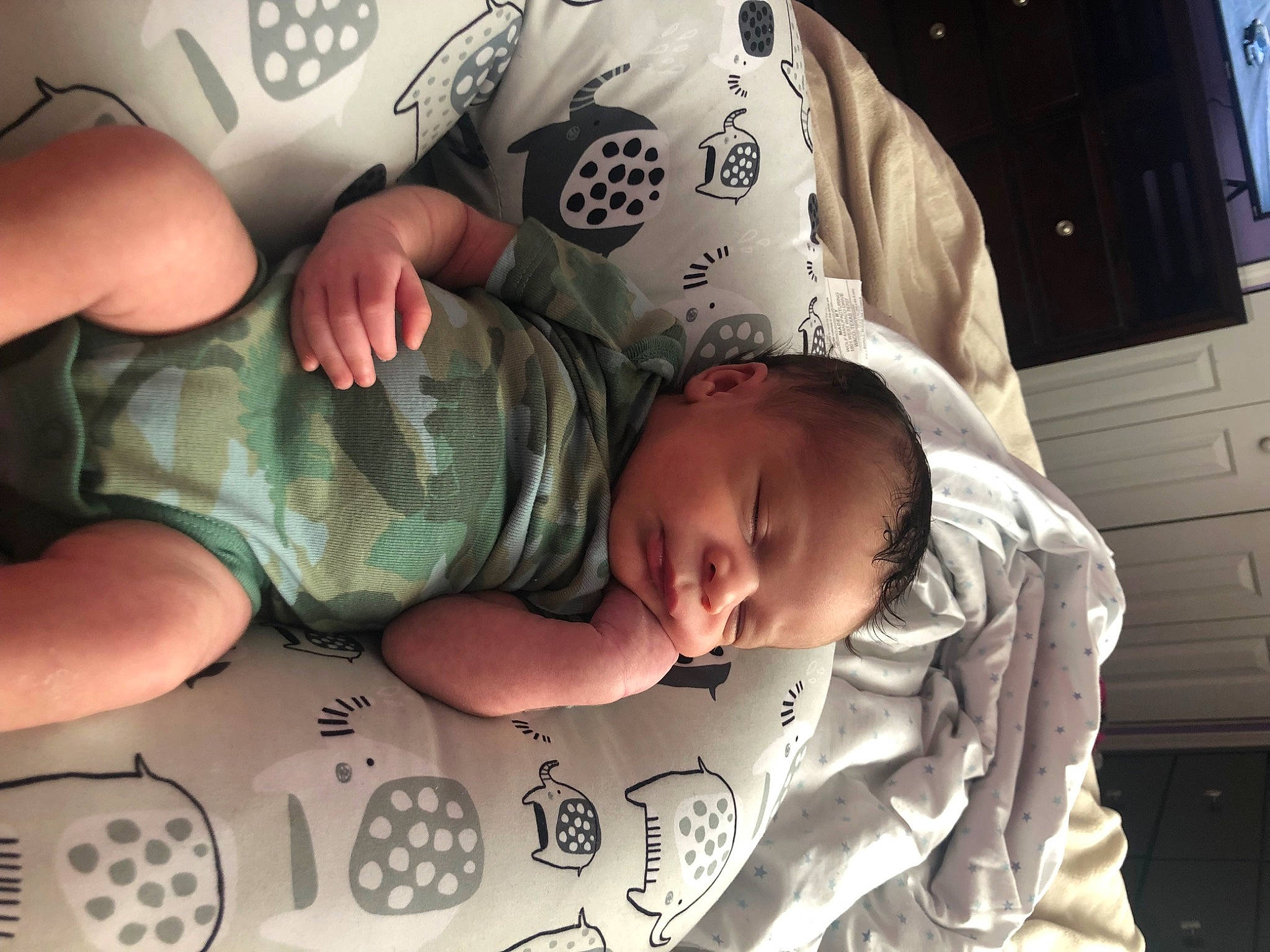 Yannis is registered to the contest to win money with this photo: arm, baby, baby_toddler_clothing, black, cabinetry, cheek, child, comfort, finger, fun, gesture, human_body, mouth, nail, organ, person, skin, snapshot, thumb, toddler