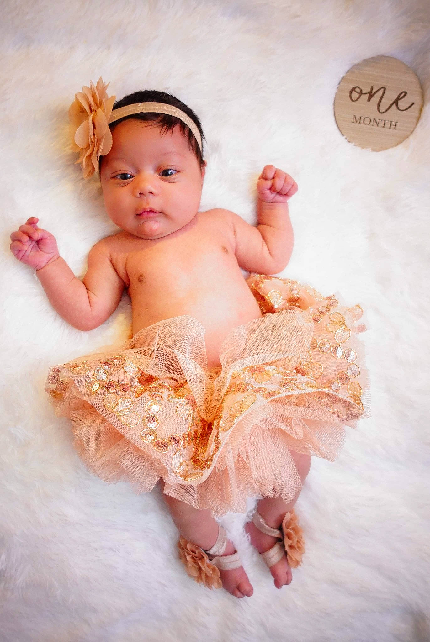Azalea is registered to the contest to win money with this photo: baby, baby_toddler_clothing, barefoot, child, costume, embellishment, fashion_accessory, flash_photography, fun, hair_accessory, happy, headband, headpiece, jewellery, peach, person, pink, sitting, skin, textile