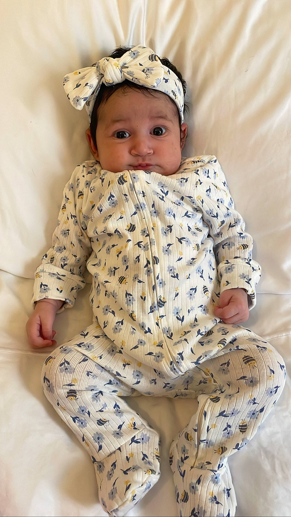 Alaiya is registered to the contest to win money with this photo: baby, baby_toddler_clothing, cap, child, collar, comfort, dress, face, happy, headgear, leg, outerwear, pattern, person, plant, sitting, skin, sleeve, textile, thigh