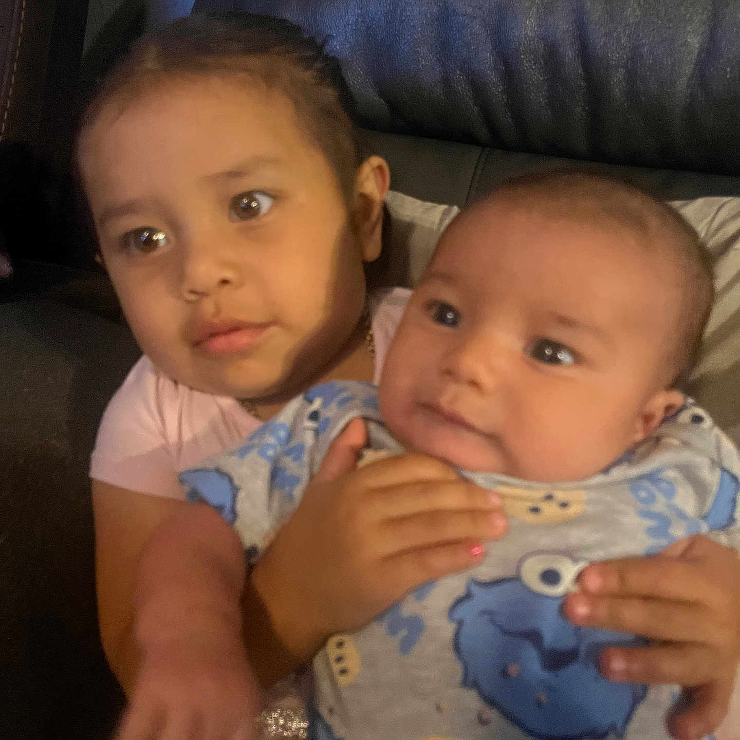 Marcus is registered to the contest to win money with this photo: child, baby, couch, holding, portrait, indoor, family, cute, toddler, clothing, person, love, comfort, face, expression, young, together, affection, home, casual
