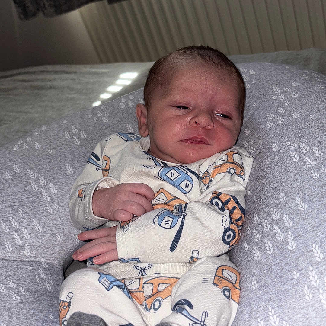 Arlo is registered to the contest to win money with this photo: baby, bed, bedroom, blanket, bodypart, couch, crib, cushion, face, finger, furniture, hand, head, homedecor, indoors, infantbed, newborn, person, photography, portrait