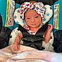 Zayla joined the competition — help win amazing prizes! baby, infant, car_seat, headband, blanket, straps, clothing, face, person, seat_belt, cute, newborn, patterned, fabric, star_pattern, sitting, indoors, soft, pink, blue
