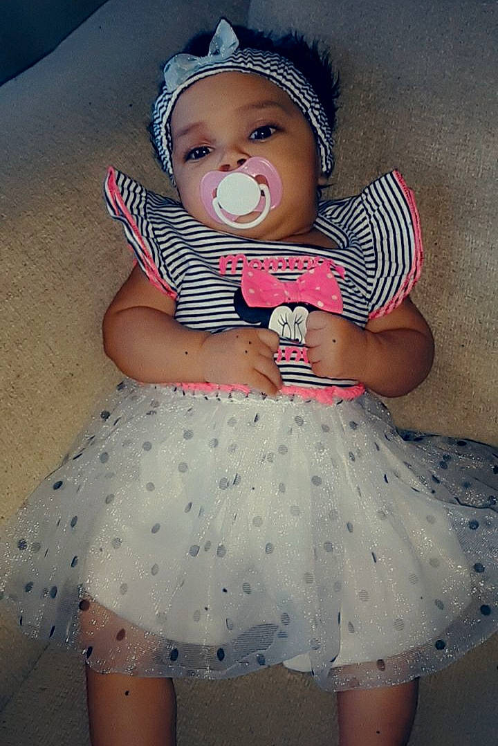 Charlee is registered to the contest to win money with this photo: baby, baby_toddler_clothing, cheek, child, clothing, eye, hair_accessory, head, headgear, headwear, pattern, person, pink, product, skin, toddler