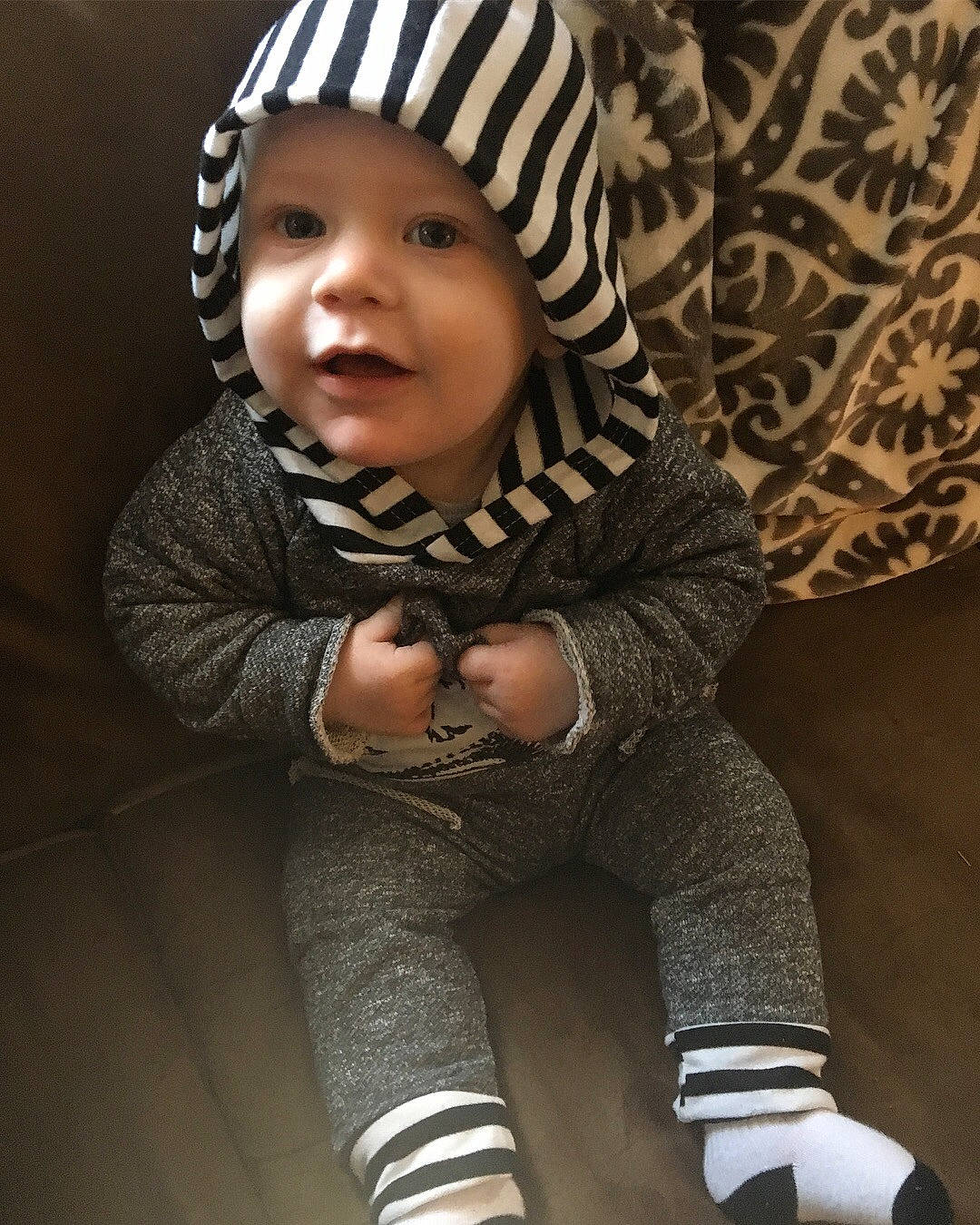 Sullivan is registered to the contest to win money with this photo: baby, beanie, cheek, child, cool, headwear, knit_cap, outerwear, person, sleeve, smile, toddler