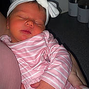 Lyla-Ann joined the competition — help win amazing prizes! baby, newborn, sleeping, pink_clothing, striped_clothing, headband, bow, hand, arm, indoor, kitchen, container, countertop, person, infant, cute, peaceful, soft_lighting, closeup, portrait